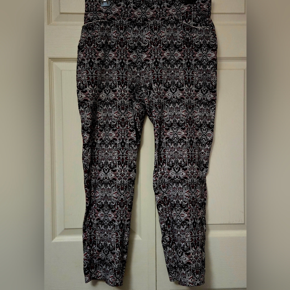 Sz. LG. Linda Matthew's pants with a black, white, and red patterned design.